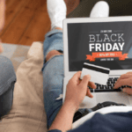 A couple on a couch shopping a Black Friday ecommerce site