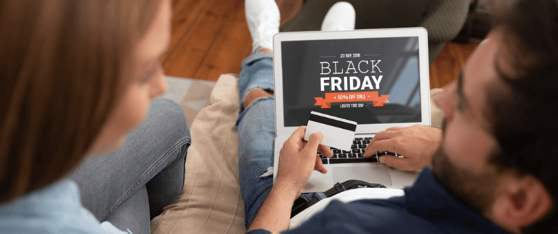 A couple on a couch shopping a Black Friday ecommerce site